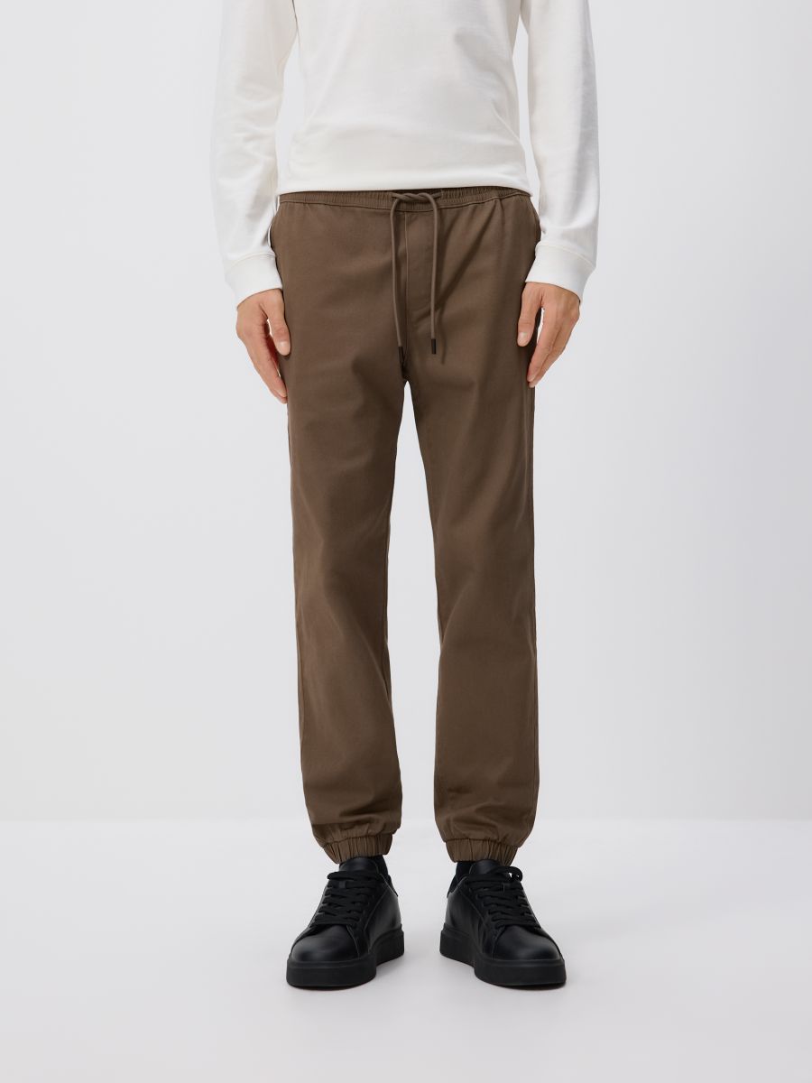 Puuvillased jogger püksid - tumepruun - RESERVED