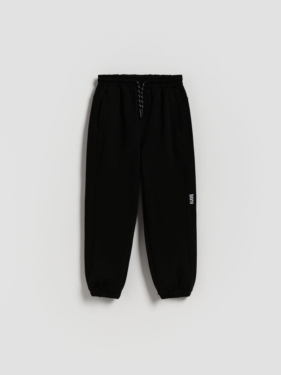 Bawełniane spodnie jogger - czarny - RESERVED