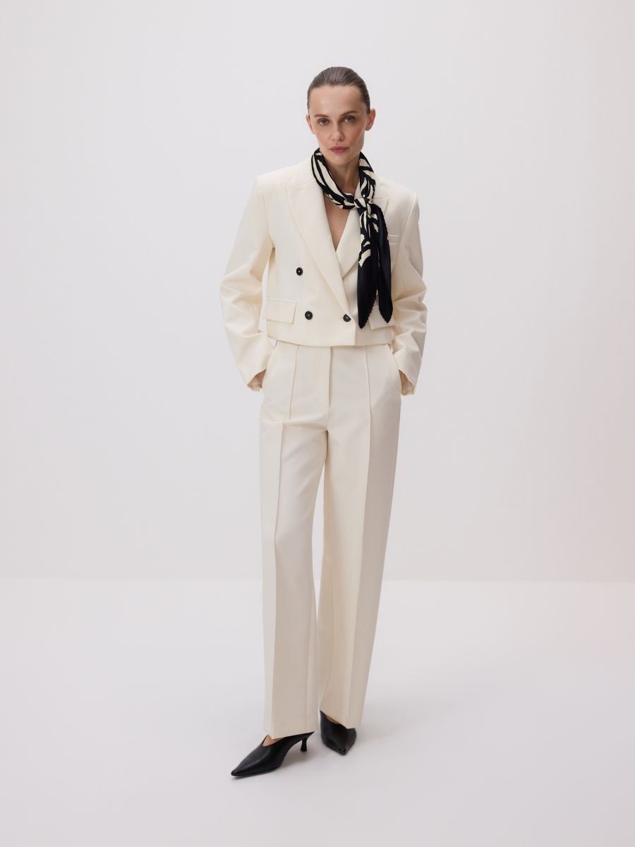 Trousers with pressed crease - cream - RESERVED