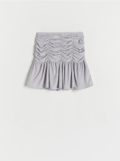 Glittrig draperad kjol