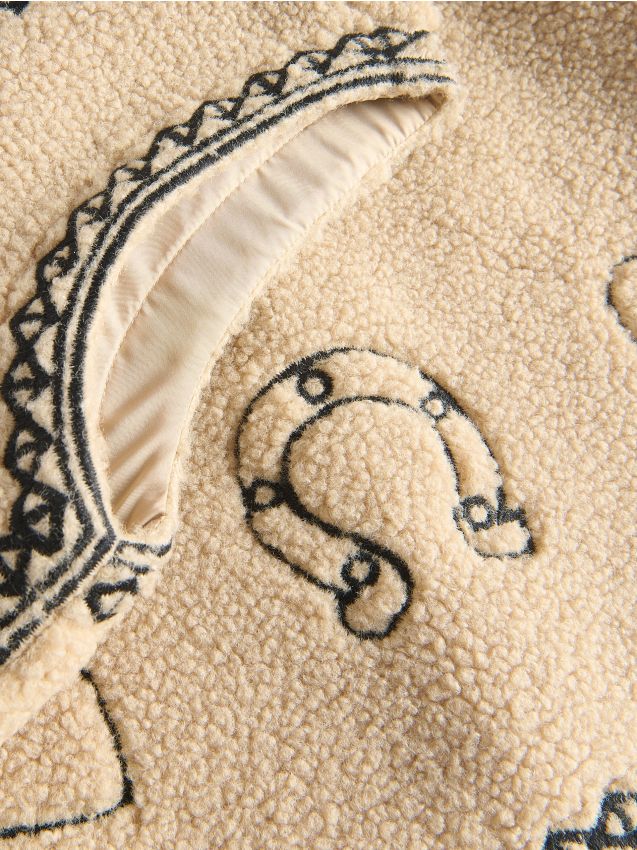 Väst med broderade detaljer - RESERVED